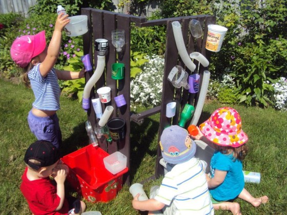 kids playing at a homemade water wall