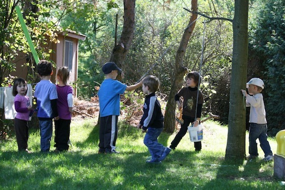 kids lined up to use our bucket and rope contraption