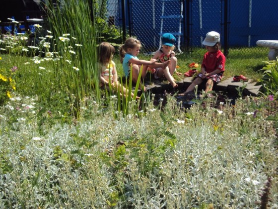 preschoolers sitting around pond