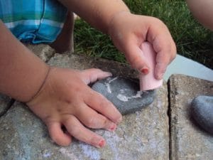 Drawing on rocks with chalk - an easy outdoor activity for toddlers