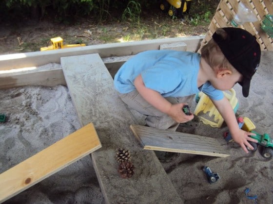 loose boards as ramps for cars in sandbox