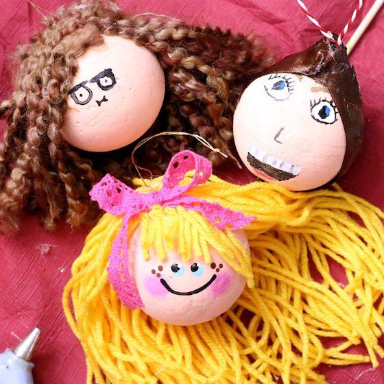 3 finished self-portrait ornaments on red tablecloth