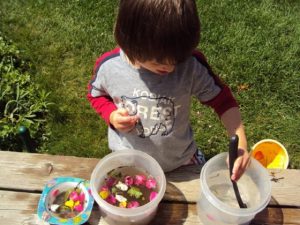 concocting "garden soup" with flowers and leaves from around the yard