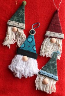 4 gnome ornaments on red background