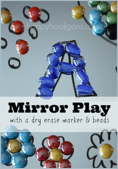 Drawing activity with mirrors and dry erase markers and glass beads