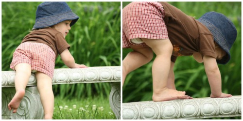 toddler balancing on a garden bench 