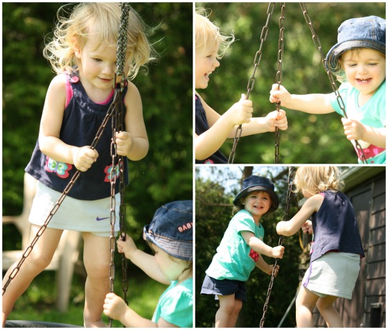 toddlers standing and balancing on the tire swing