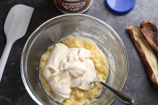 mashed bananas and mayonnaise in glass bowl 