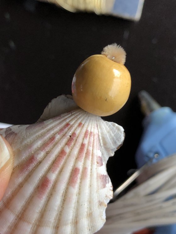 angel ornament with seashell and wooden bead