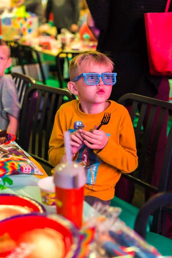 Boy wearing sunglasses at Chuck E. Cheese's party