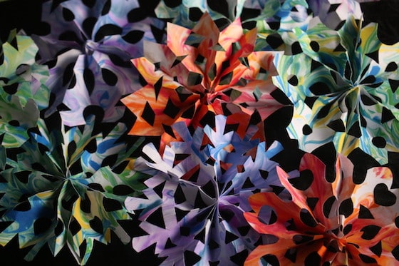 pile of colourful 3d paper snowflakes