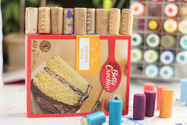 cake box with wine corks lined up on long side