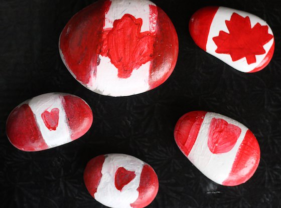 Beach Rocks painted to look like Canadian Flags