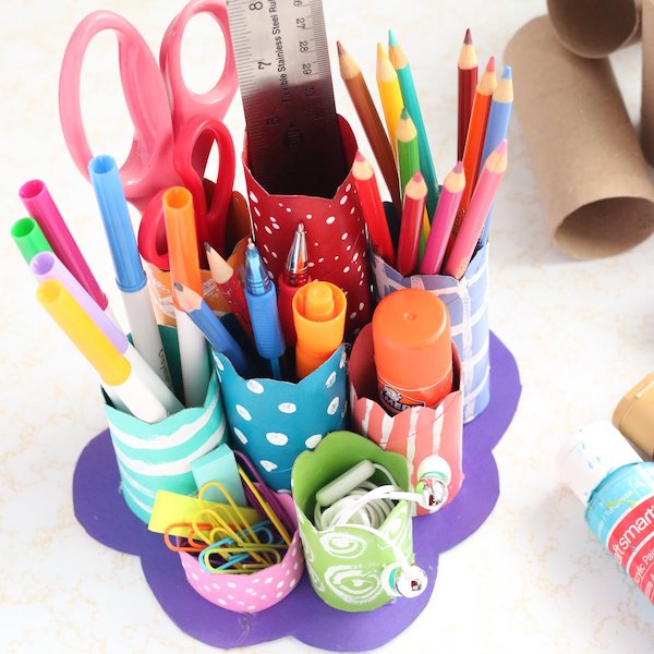 homemade cardboard roll desk caddy filled with art supplies