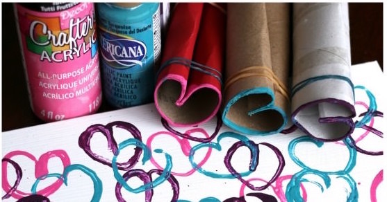 Stamped hearts on a canvas with toilet rolls