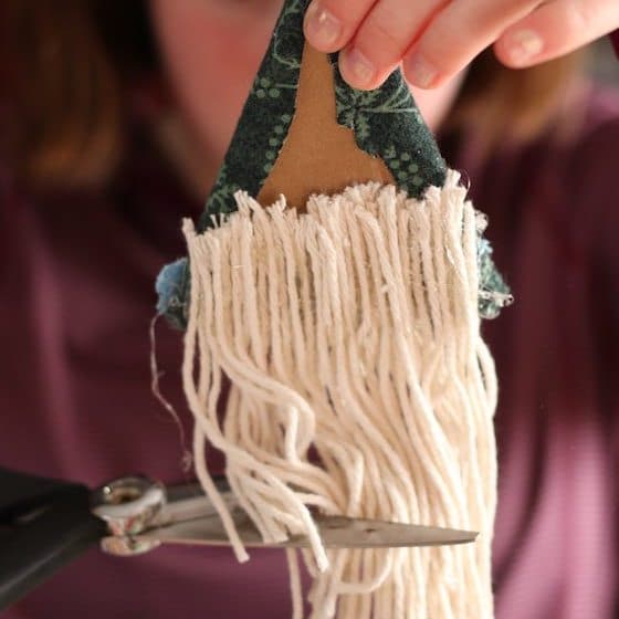 kid cutting yarn for gnome beard