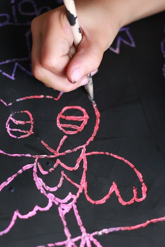 child drawing owl with scratch art