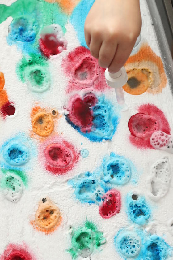 kids spraying baking soda with vinegar