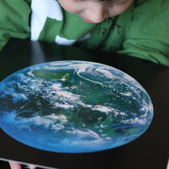 Child looking at satellite picture of Earth 