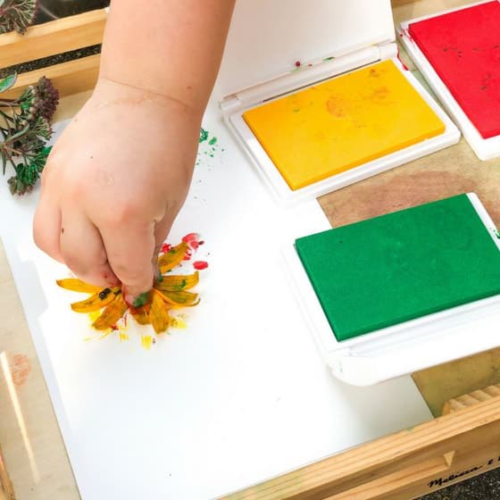 child making flower stamp on paper