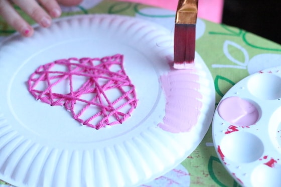 child painting a paper plate