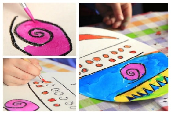 child painting paper Easter egg with watercolour paints