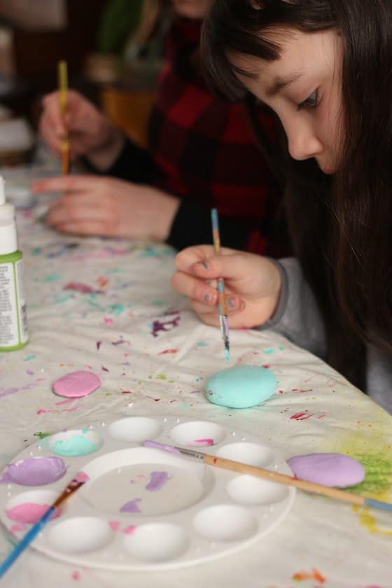 Kids painting stones in Easter colours