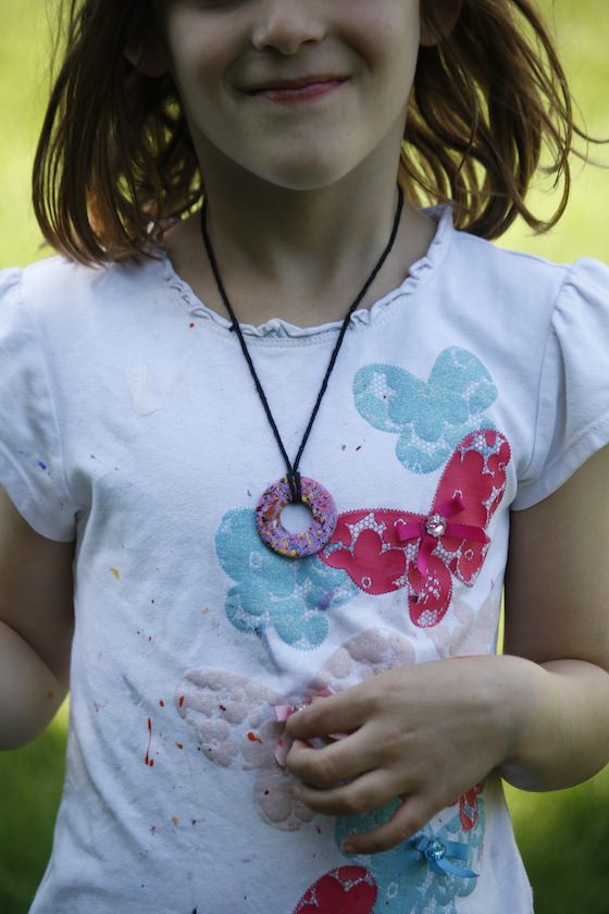 child wearing painted washer necklace