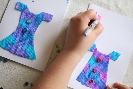 child writing on homemade mother's day card