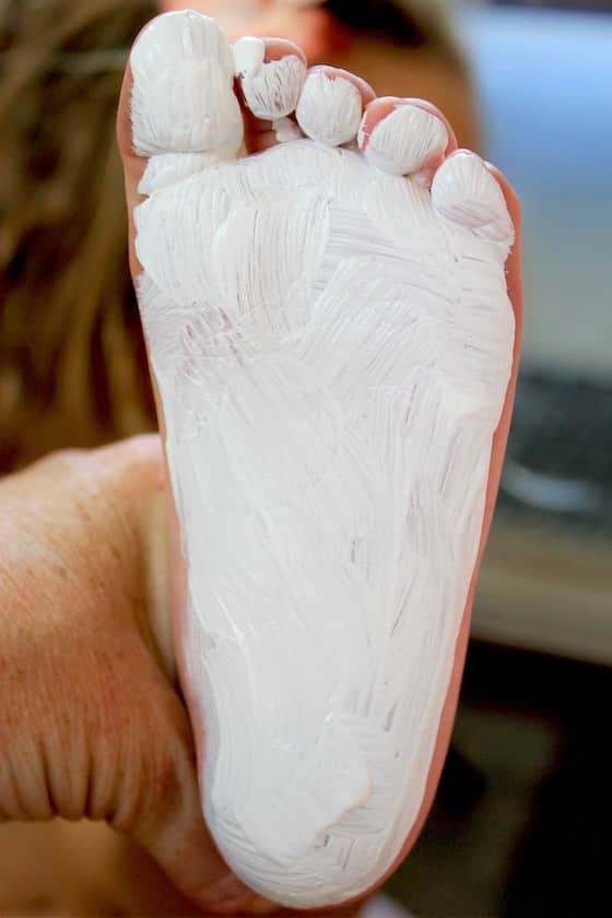 Child's foot painted white