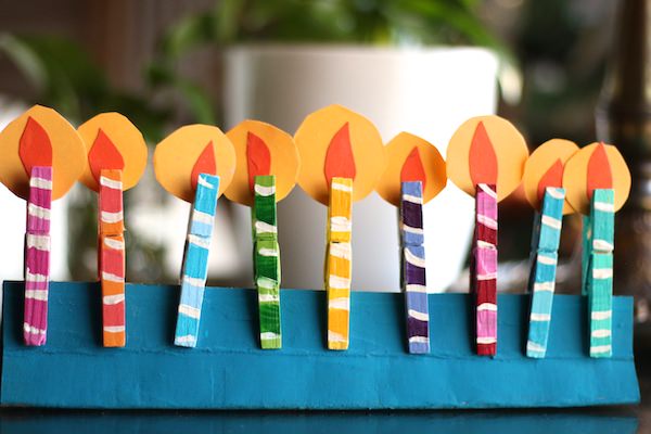 clothespin menorah with paper flames on table