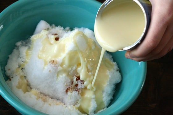 pouring condensed milk over and snow and vanilla