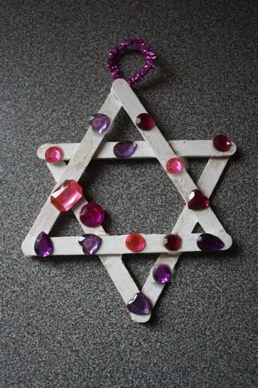 craft stick jewelled star ornament made by toddler