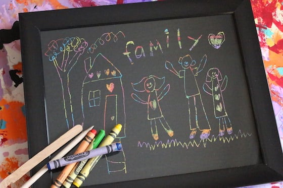 crayons craft sticks and scratch art drawing in black frame