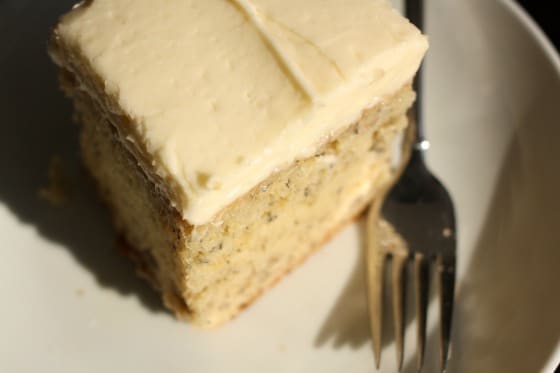 Overhead shot of Best Banana cake with cream cheese icing, plate and fork