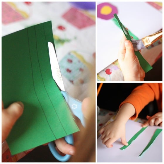 preschooler cutting paper flower stems