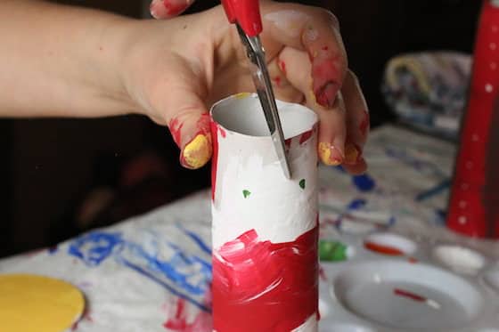 cutting slit in red and white paper towel roll