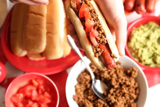 diced tomatoes on a taco hotdog