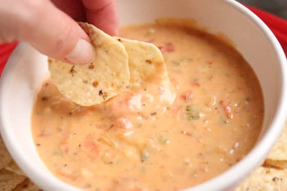 dipping tortillas in hot cheese dip