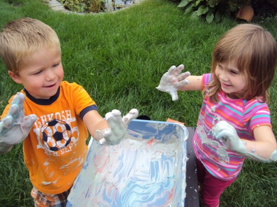 toddlers playing with shaving cream sensory bin 