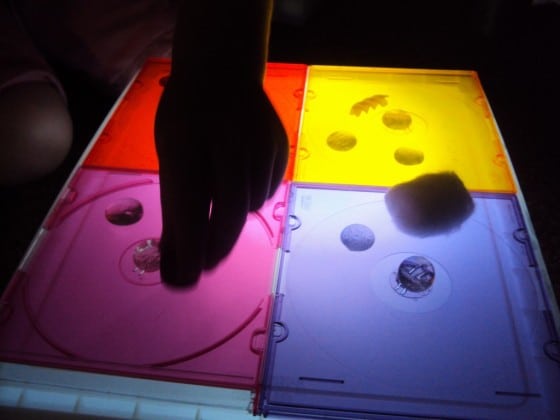 Coloured CD cases for play on a DIY light box.