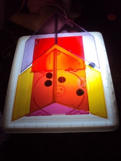 Playing with coloured CD cases on the homemade light box.