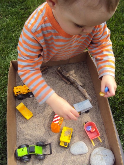 construction vehicles and glass beads in a cardboard box