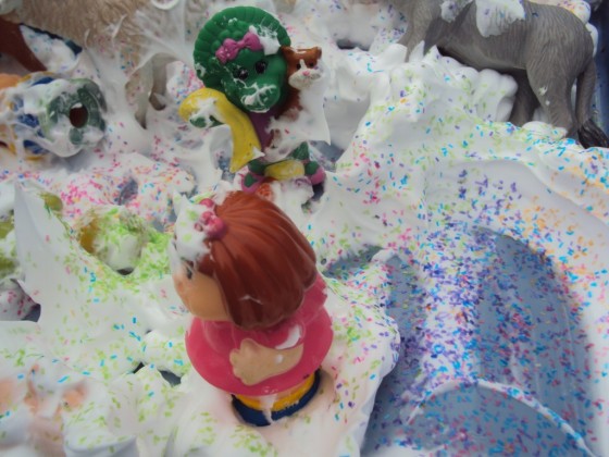 toys in the shaving cream and glitter sensory bin