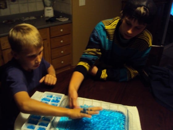 boys playing with water beads