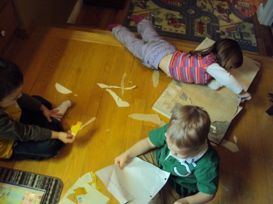 kids cutting paper to make paper cones