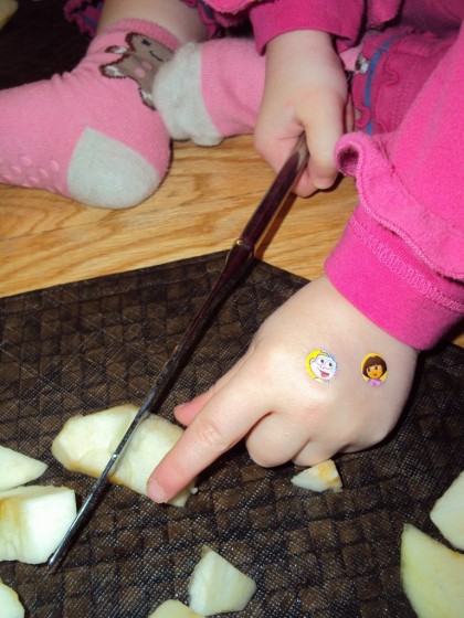 toddler cutting apple with knife