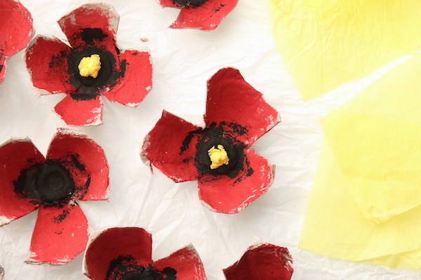 Egg carton poppies and yellow squares of tissue paper