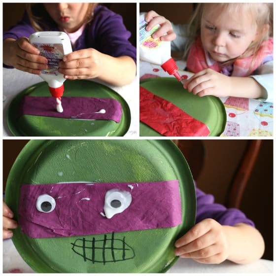 Gluing googly eyes on Teenage Ninja turtle craft