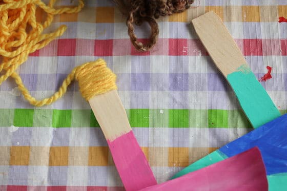 gluing yarn to paint stick